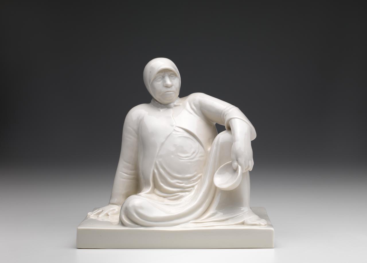 Ernst BARLACH (designer)<br />
 SCHWARZBURGER WERKSTÄTTEN FÜR PORZELLANKUNST, Schwarzburg (manufacturer)<br/>
<em>Russian beggar woman with a bowl</em> (1906) {designed}; (1912-1913) {manufactured} <!-- (front view) --><br />
<em>(Russische Bettlerin mit Schale)</em><br />
porcelain<br />
24.5 x 25.2 x 18.5 cm<br />
National Gallery of Victoria, Melbourne<br />
Gift of Edith Gordon, 2012<br />
2012.269<br />

<!--104044-->