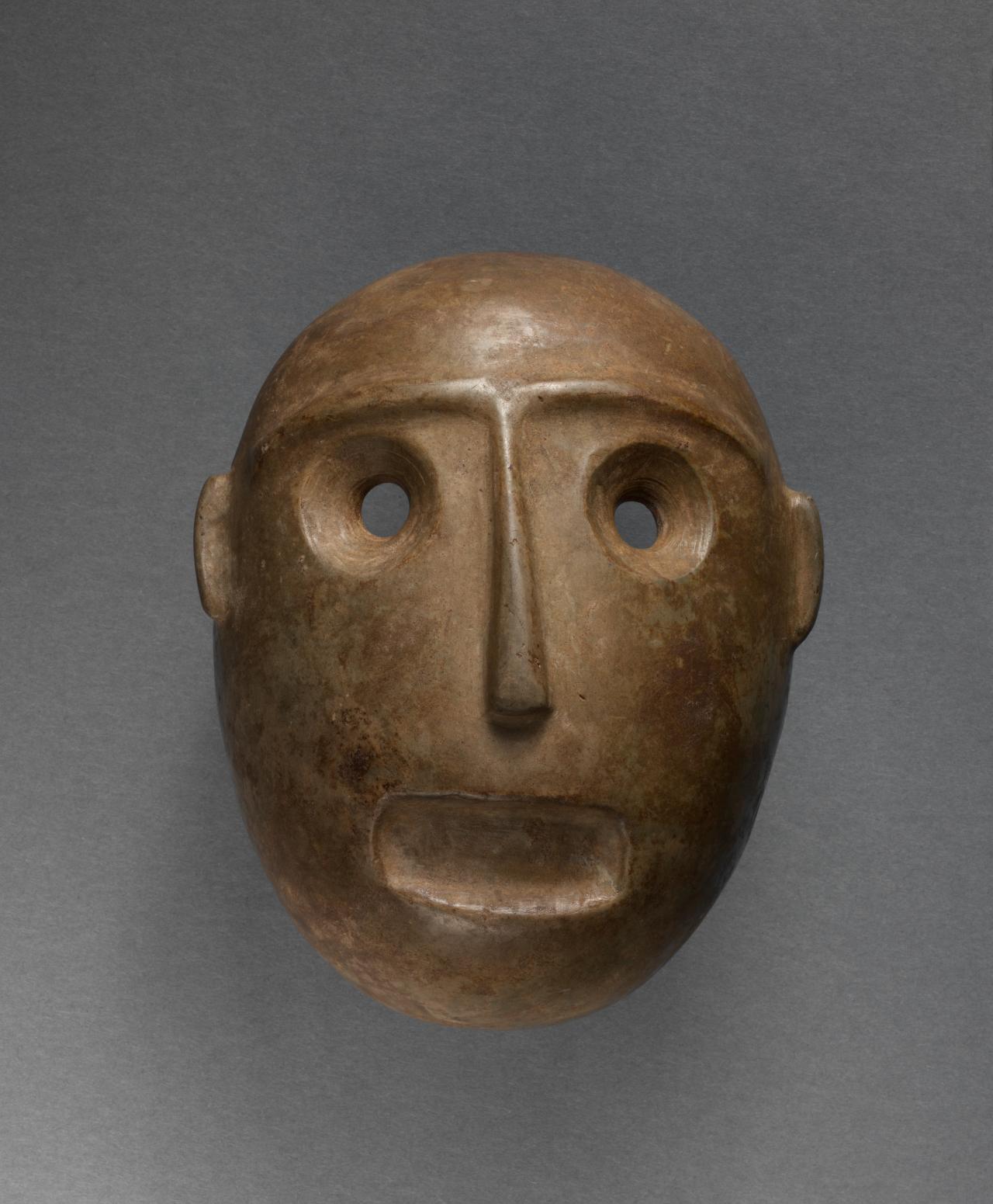 Colima, West Mexico<br/>
<em>Mask</em> 400 BCE-200 BCE <!-- (front view) --><br />

serpentine<br />
17.2 x 13.5 x 7.5 cm<br />
National Gallery of Victoria, Melbourne<br />
Purchased through The Art Foundation of Victoria with the assistance of Colgate-Palmolive Pty Ltd, Fellow, 1982<br />
PC11-1982<br />

<!--182-->