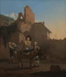 Man on a donkey halting for refreshment before a ruin